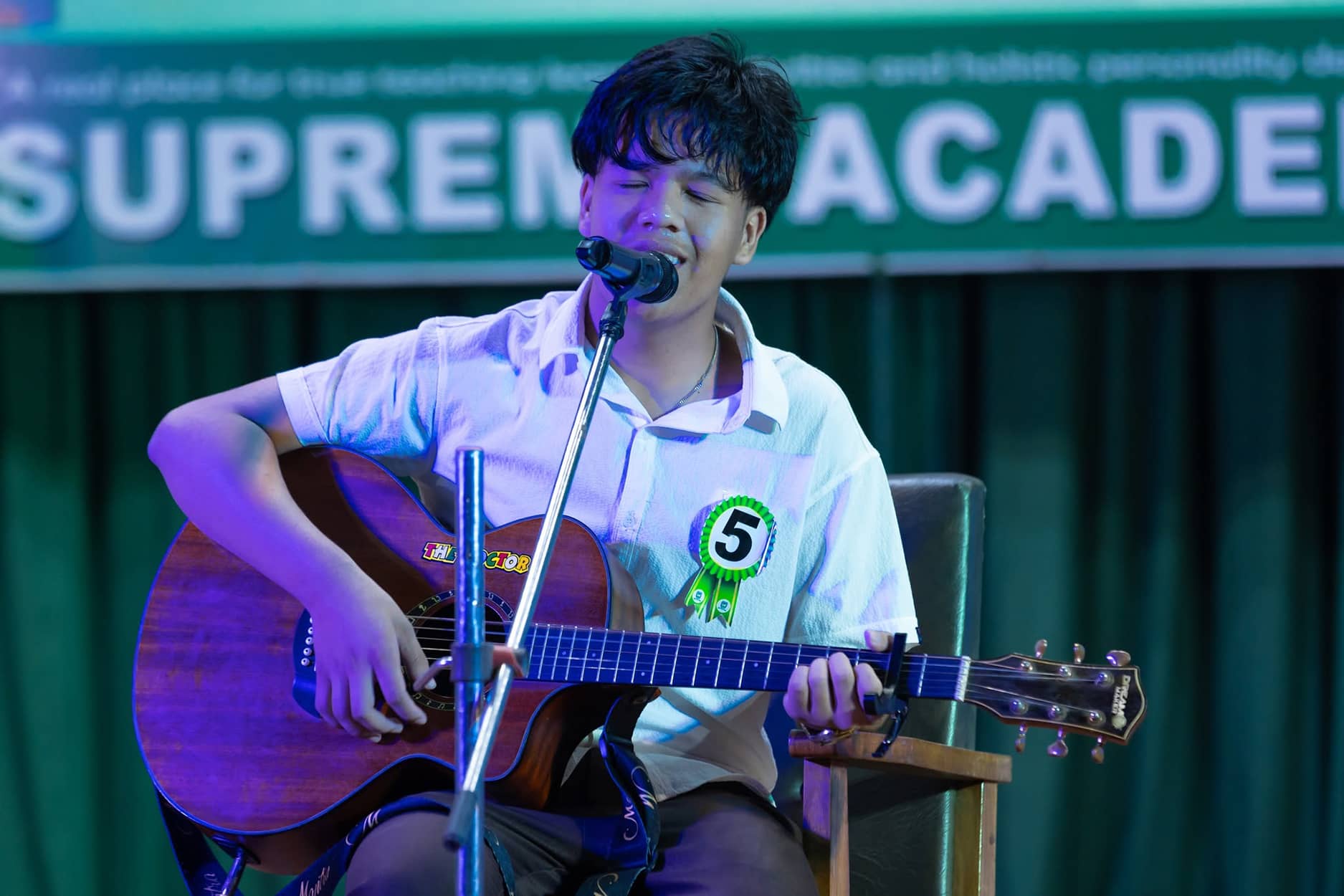 Supreme Academy students performing on stage at a school function